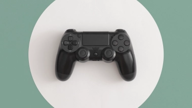 A black video game controller on a white and green background.